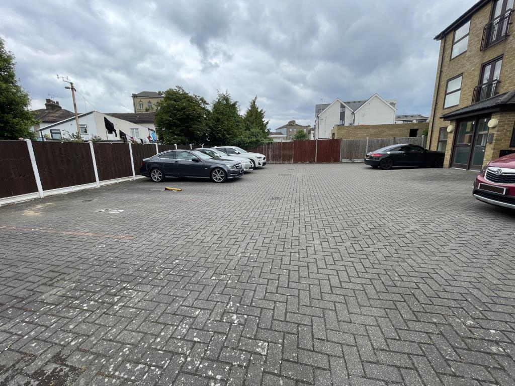 Lot: 58 - ENTIRE FREEHOLD BUILDING OF SIX FLATS, ALL LET ON ASSURED SHORTHOLD TENANCIES - outside image of parking area from gate